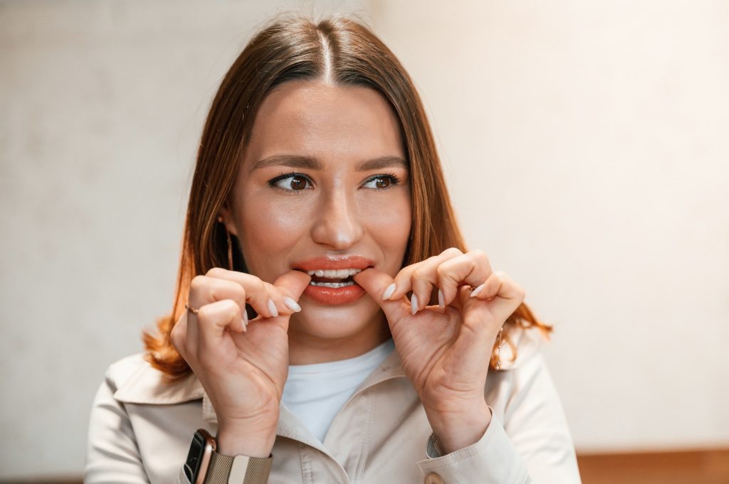Woman is touching aligner by the hands